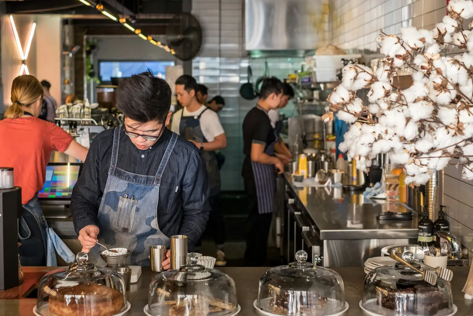 Busy baristas and kitchen staff in a café