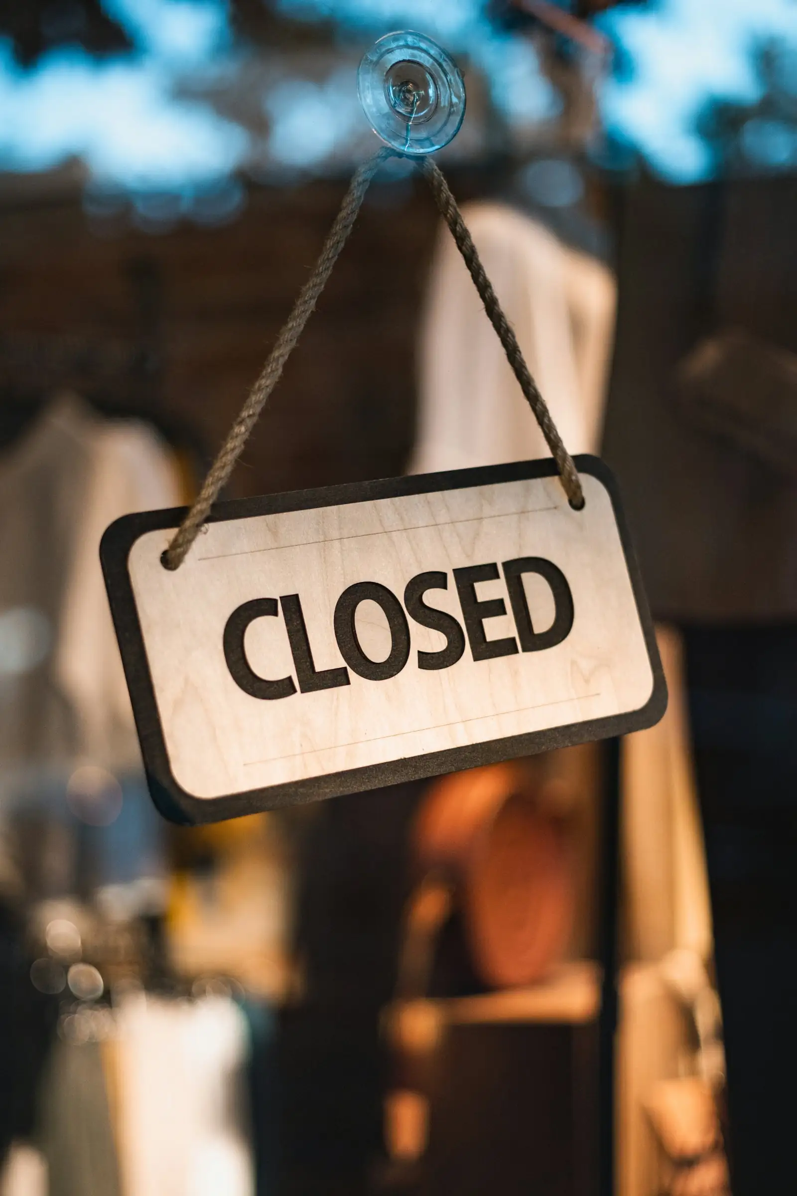 Closed sign hanging in a shop window