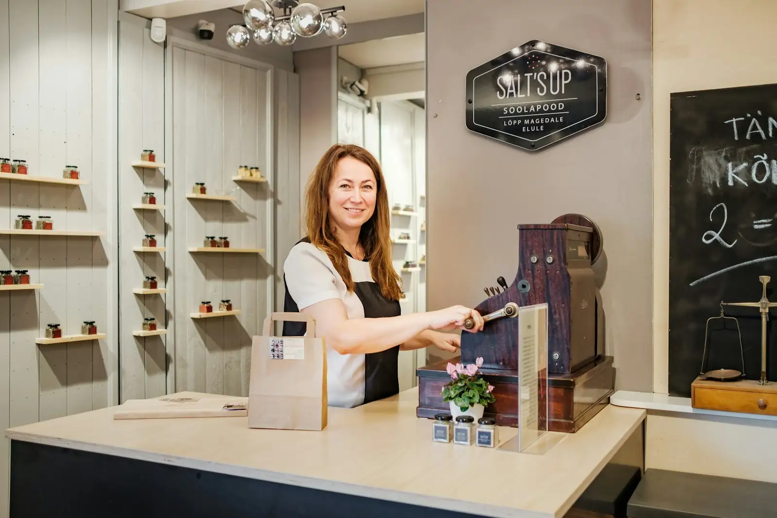 Retail owner serving at the counter of her store
