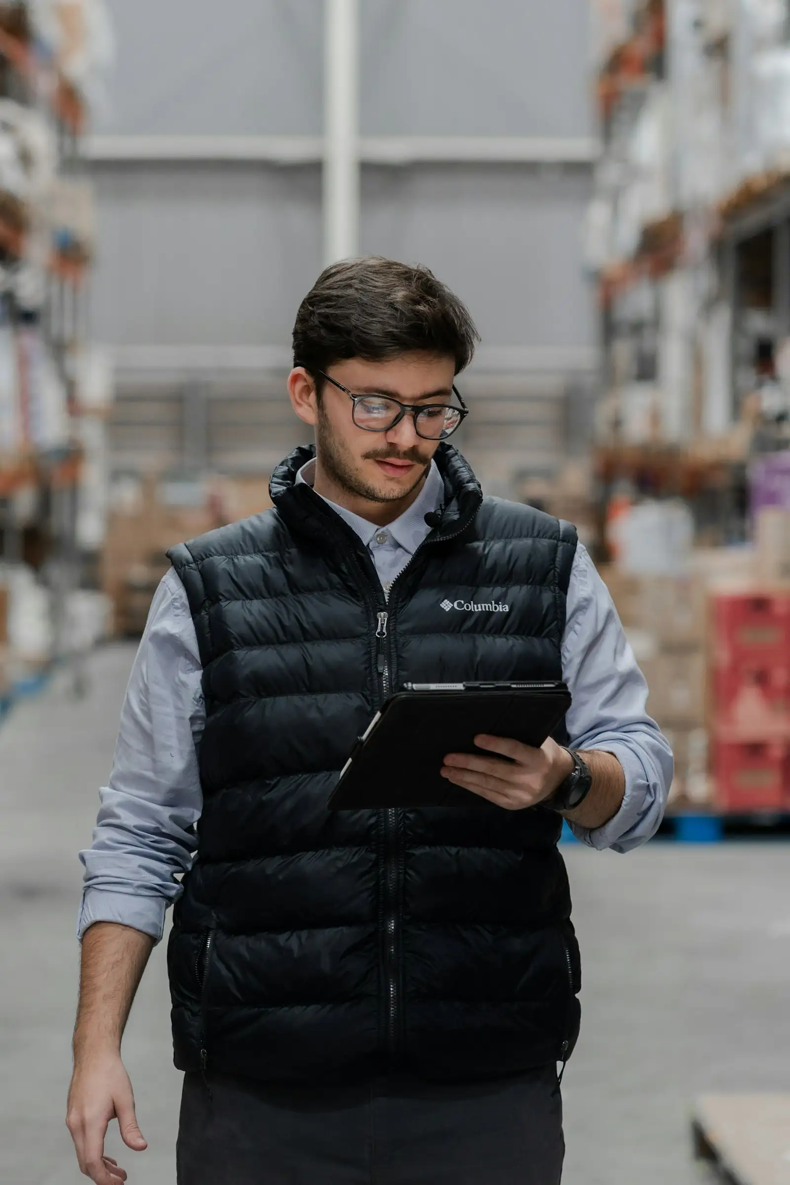 Warehouse manager checking stock on a tablet